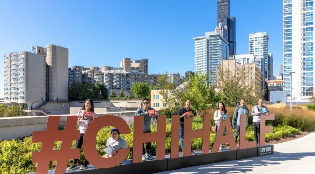 People posing behind #CHIHALF outdoor sign