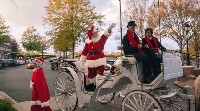 Santa being pulled on horse carriage