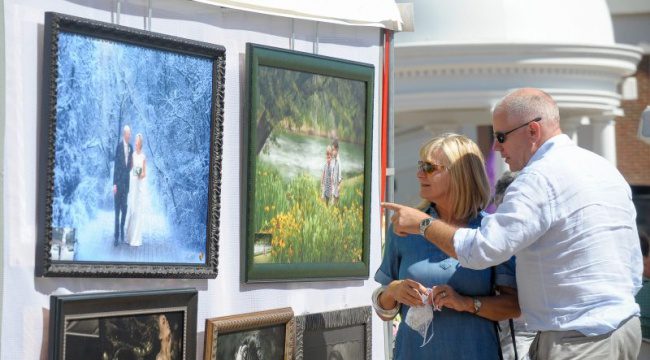 Man and woman looking at framed art