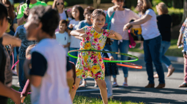Little girl using hula hoop