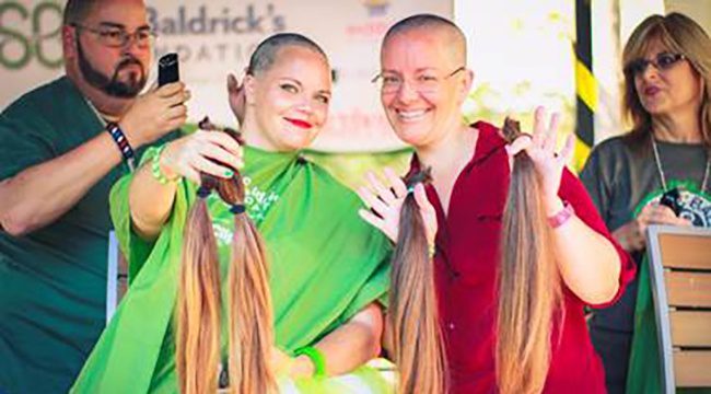StBaldricks2_650x360_acf_cropped Two woman holding up hair they just shaved and are donating