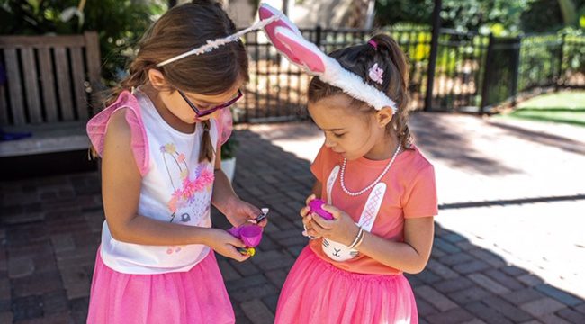 Two small girls with easter dresses and egg