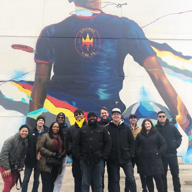 Max_15-640x640 Diverse group of poeple in front of large mural